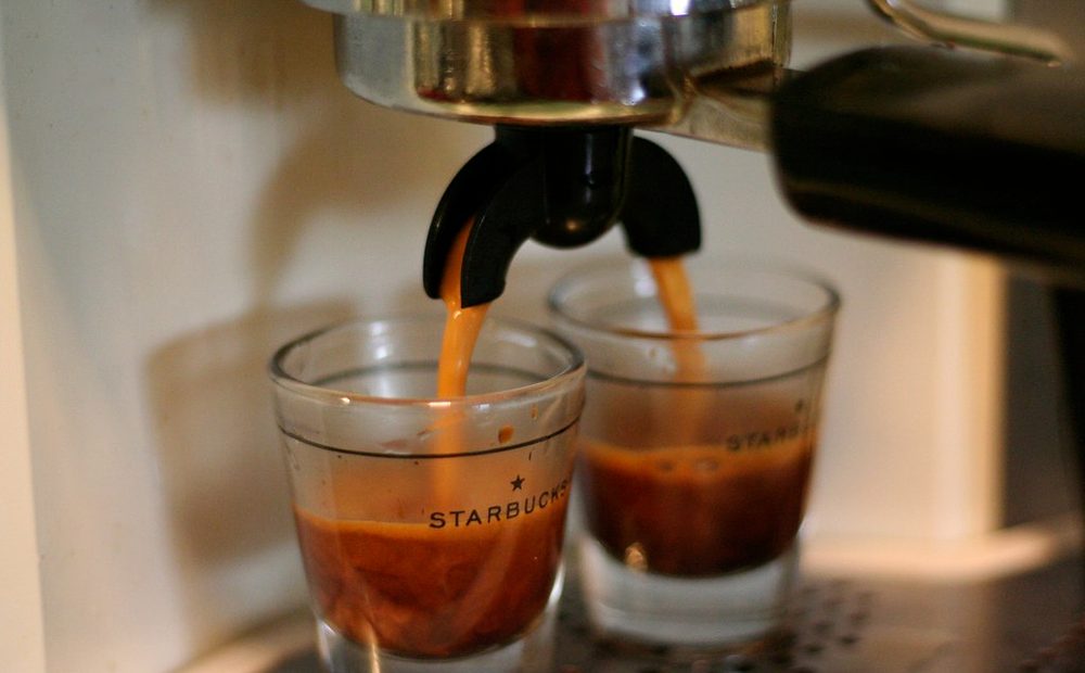 my espresso machine on the bar, portafilter locked in, mid-shot with crema pouring (placeholder)