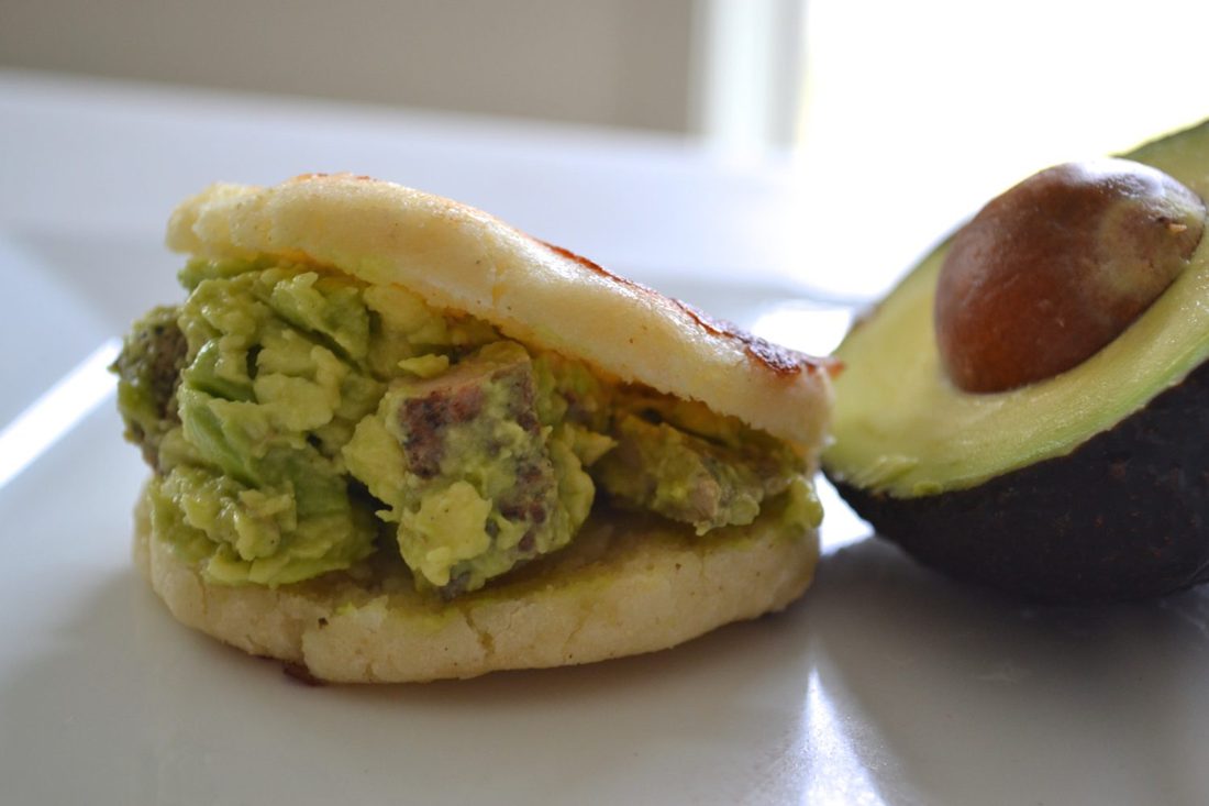 An arepa split open and stuffed