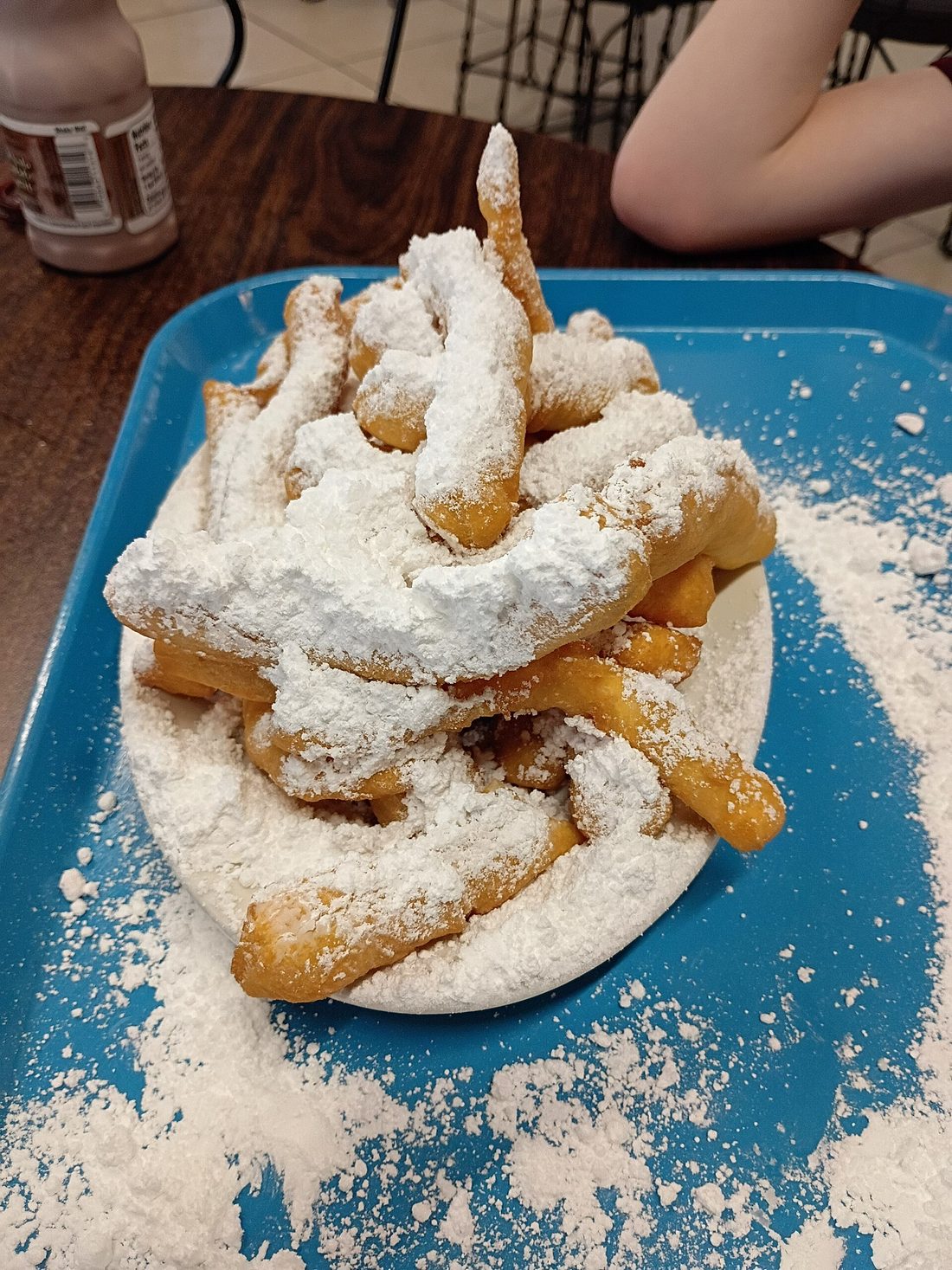 Beignets under a heavy drift of powdered sugar
