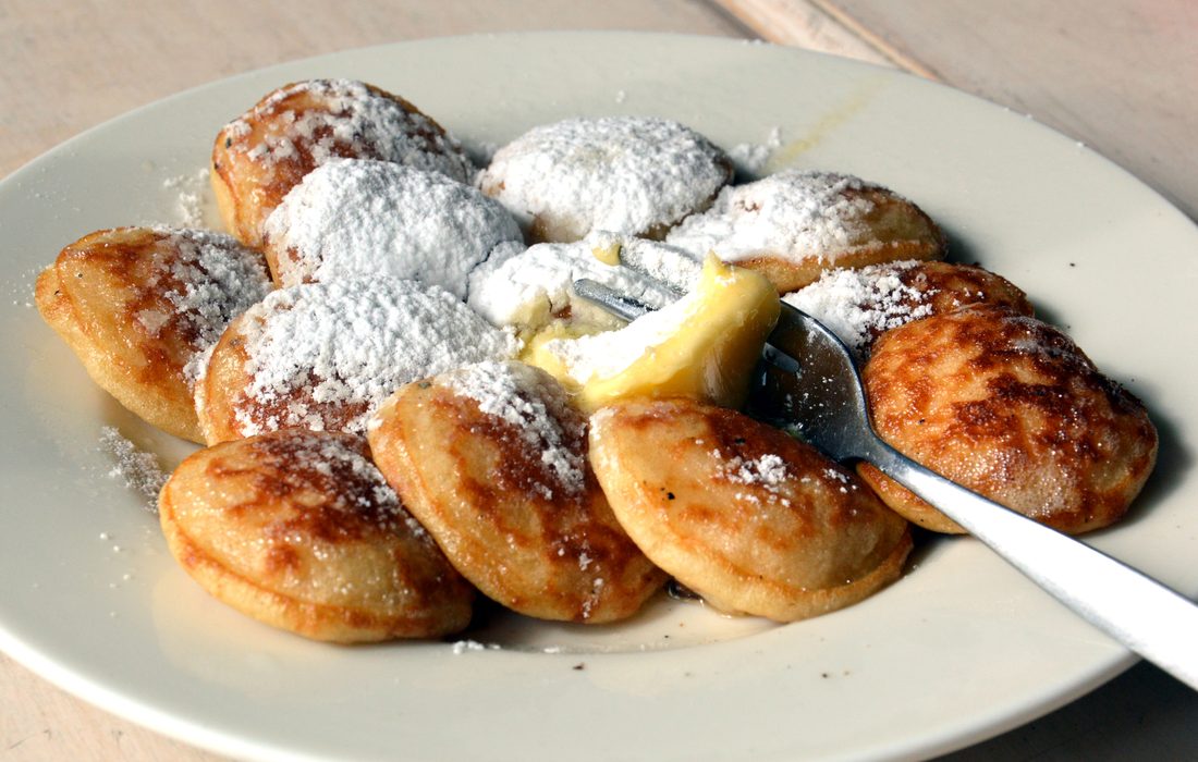 Poffertjes — small Dutch pancakes cooking in a dimpled pan