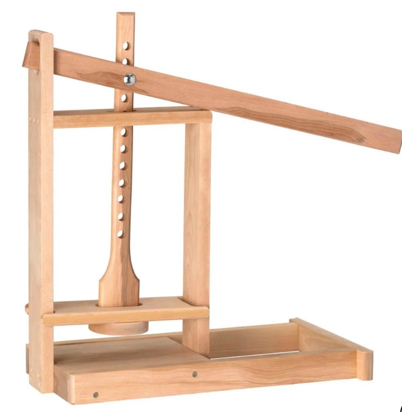The Dutch-style lever press: a long wooden arm pivoted at the upright, bolted through a vertical post
drilled with a column of holes, pressing a turned plunger down onto a mould, over a draining board with a
raised lip and a run-off channel.