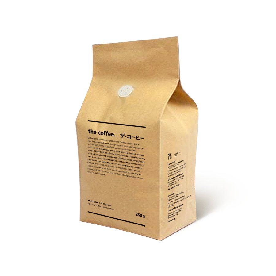 A kraft paper block-bottom coffee bag with a one-way valve near the top and small printed text