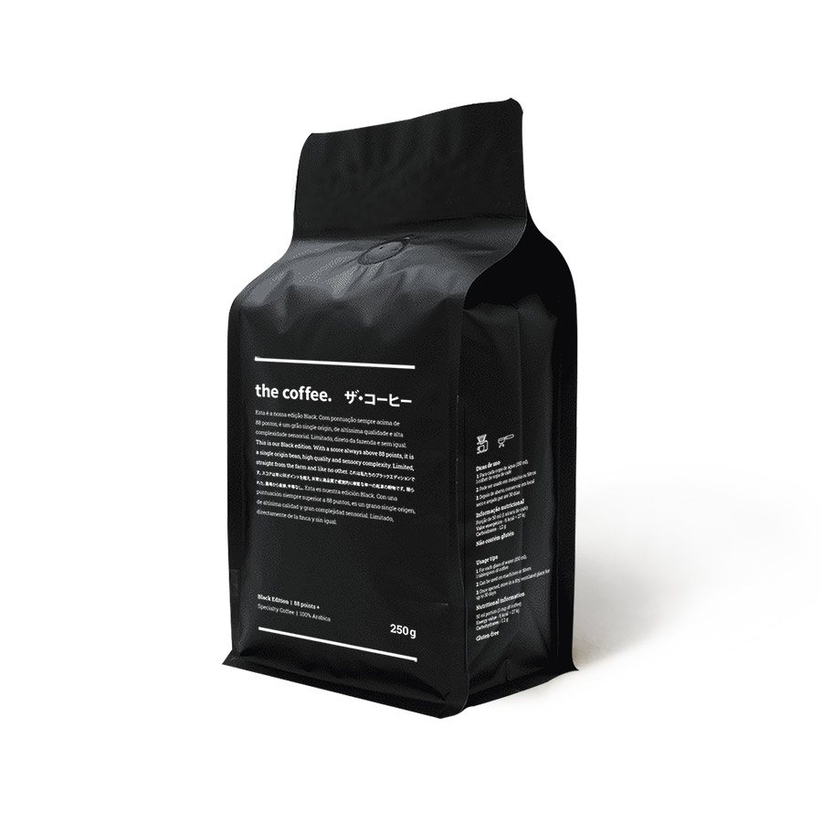 A matt black block-bottom coffee bag standing upright, with small white text on the front