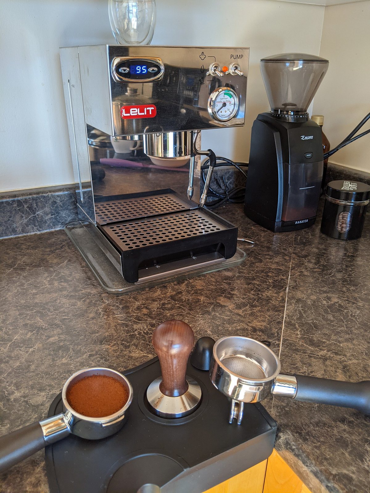 A home pump machine with its grinder beside it — which is the correct proportion of attention, since the grinder is the harder half of the problem