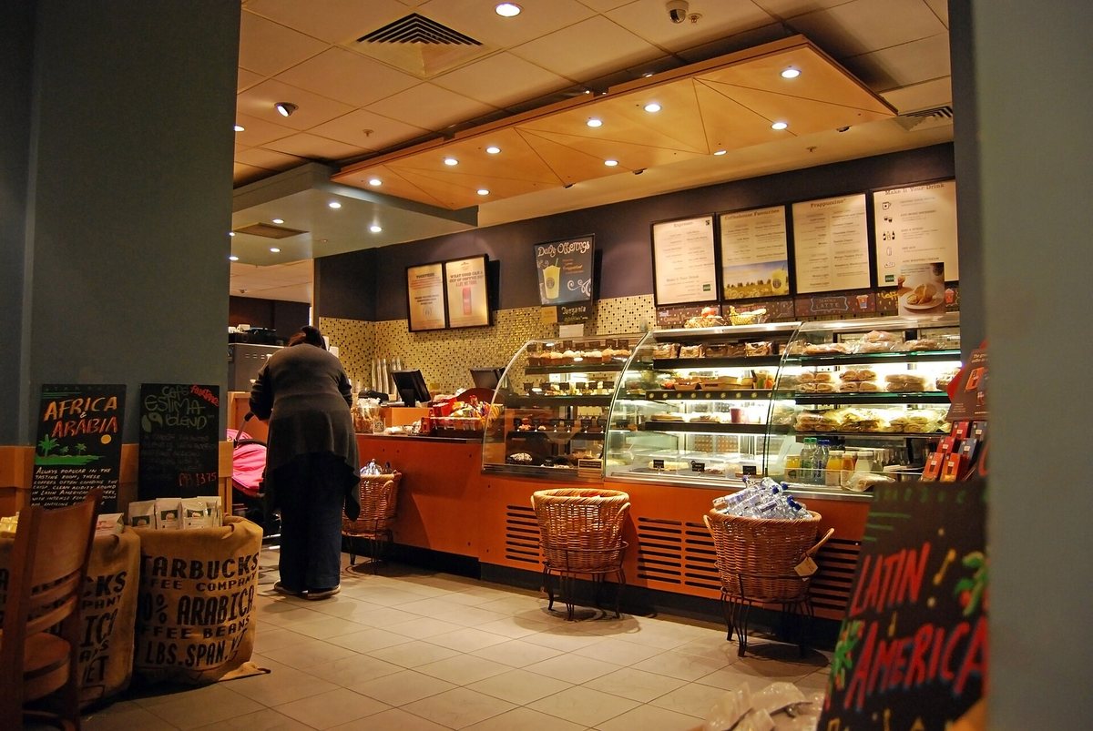Second wave, and its whole thesis in one frame: not a drink, a place you go. Mock the roast profile if you like — this room taught a continent that coffee has a menu