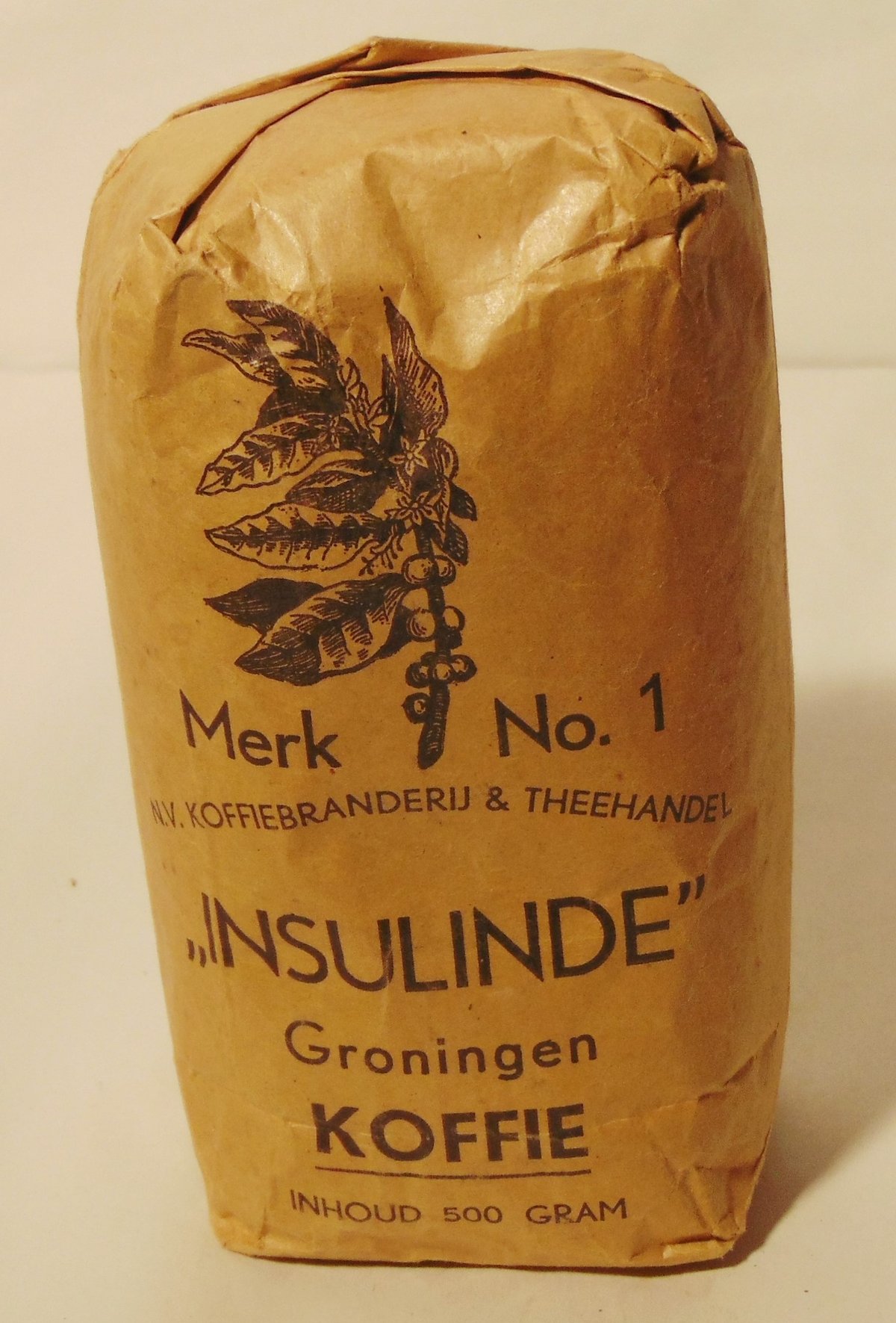 A brown paper half-kilo coffee packet printed with a coffee branch and the words Insulinde Koffie, Groningen, from the 1940s