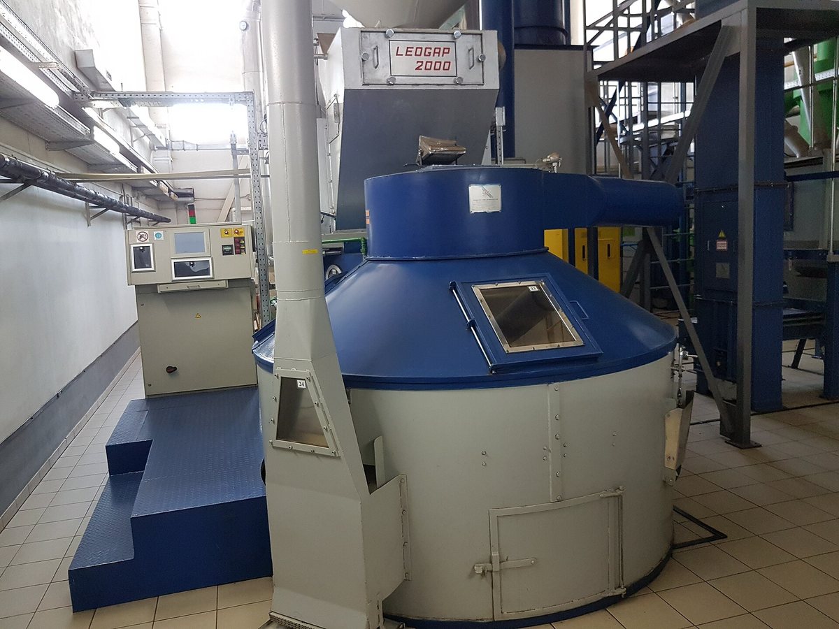 Production-scale drum, in the blue paint and stair-access that tells you the operator can't reach the top of it from the floor