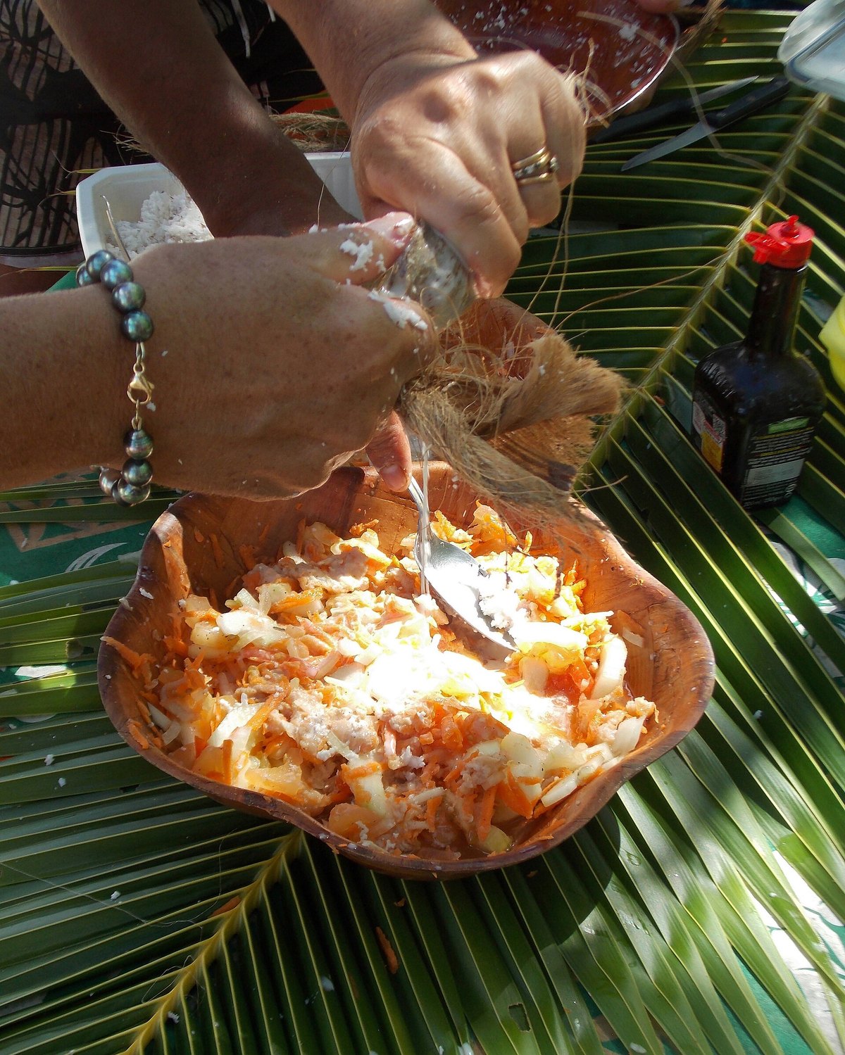 Coconut milk being pressed from grated flesh — where the fat that does all this work comes from