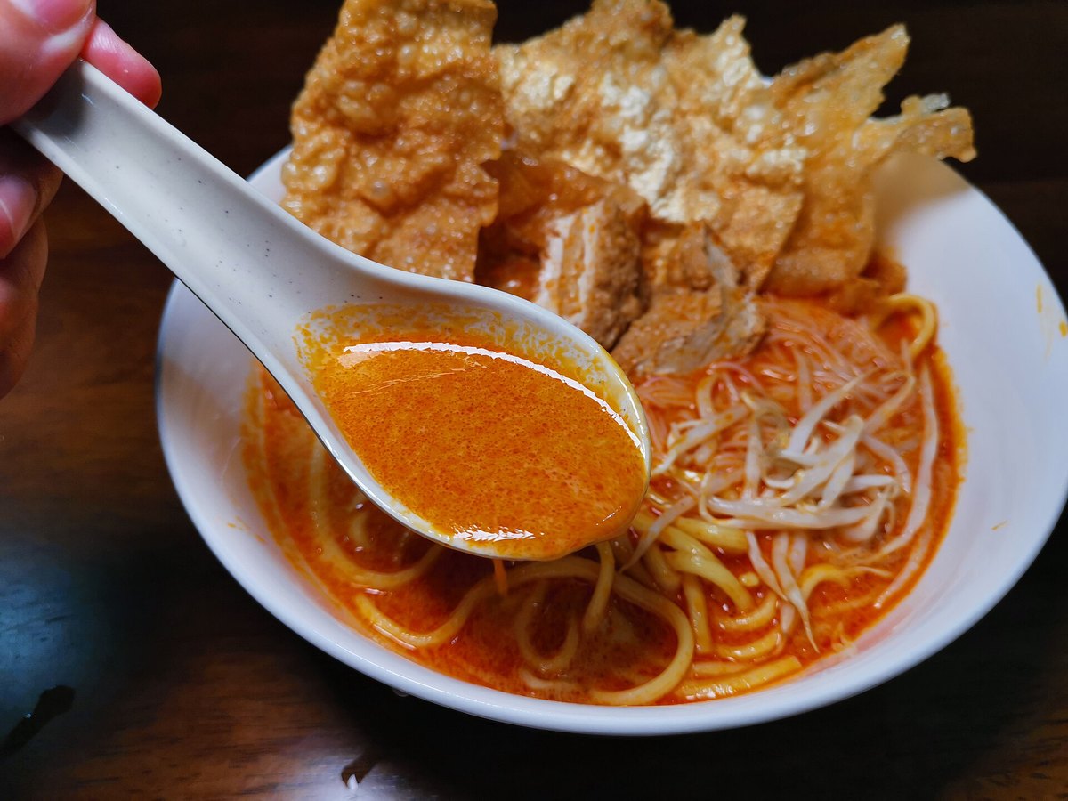 Laksa — noodles, bean sprouts and fried tofu puffs in an orange coconut-curry broth