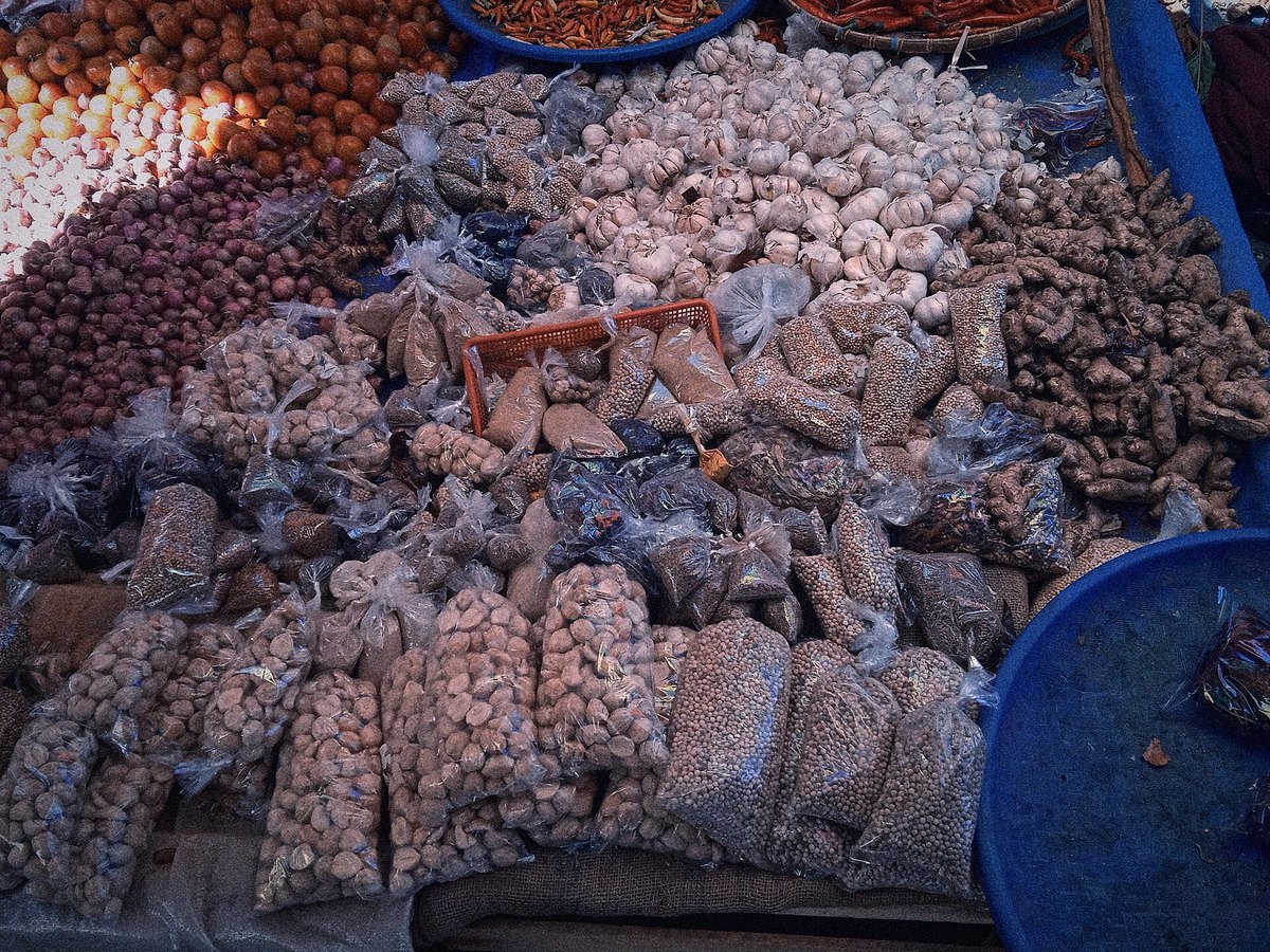 A Southeast Asian market spice stall — the sacks and heaps a bumbu is built from