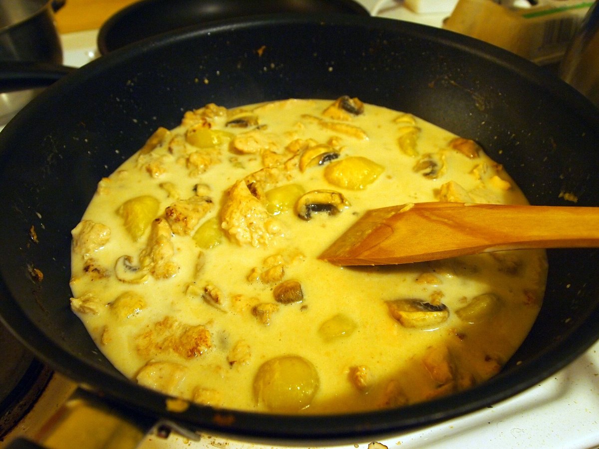 Yellow curry in the pan, pale gold from the turmeric