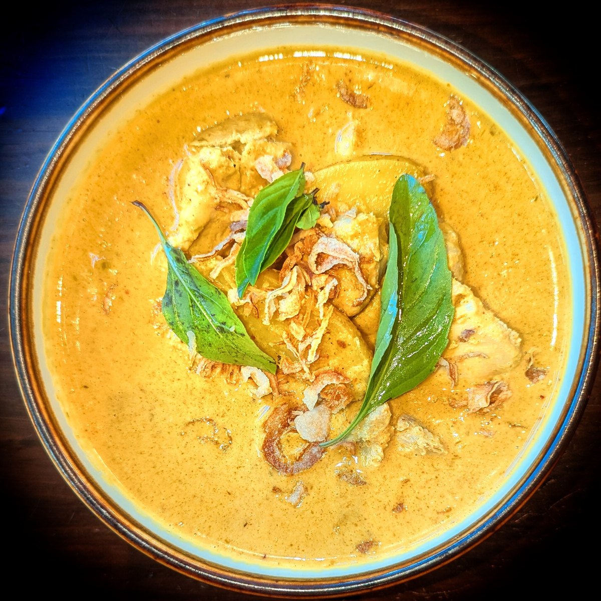 A yellow curry with chicken and potato, distinctly more golden and less herbal-looking than red or green