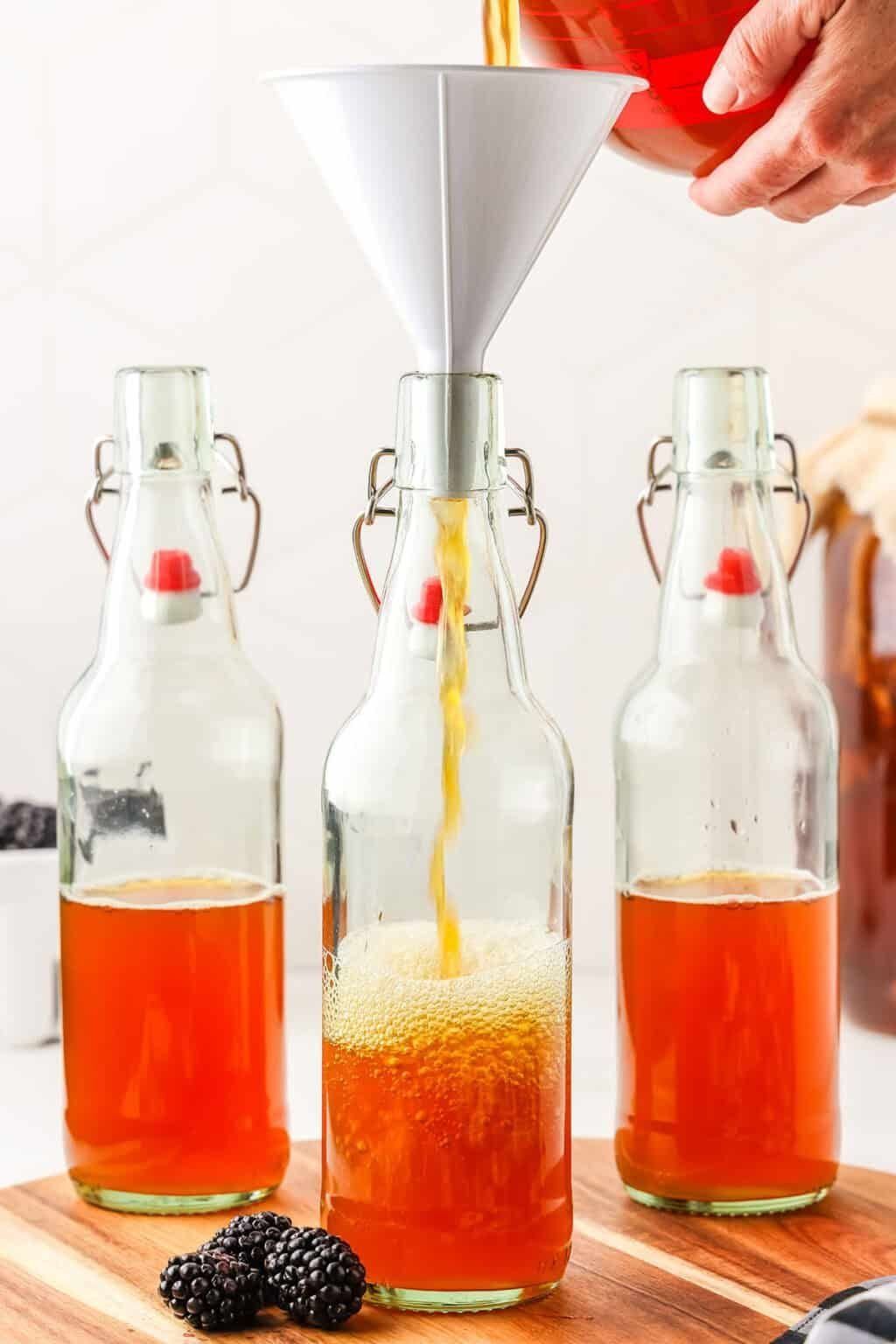 Filling swing-top bottles for the second ferment. The bottle has to be able to take pressure, because this is the step that makes it