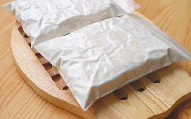 A finished tempeh cake. The white mycelium is structural — it is what turns loose beans into something you can slice