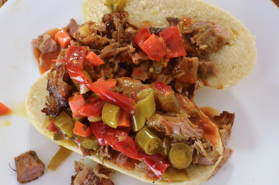 A sandwich of smoked pork heaped with chopped Chicago-style hot giardiniera in oil