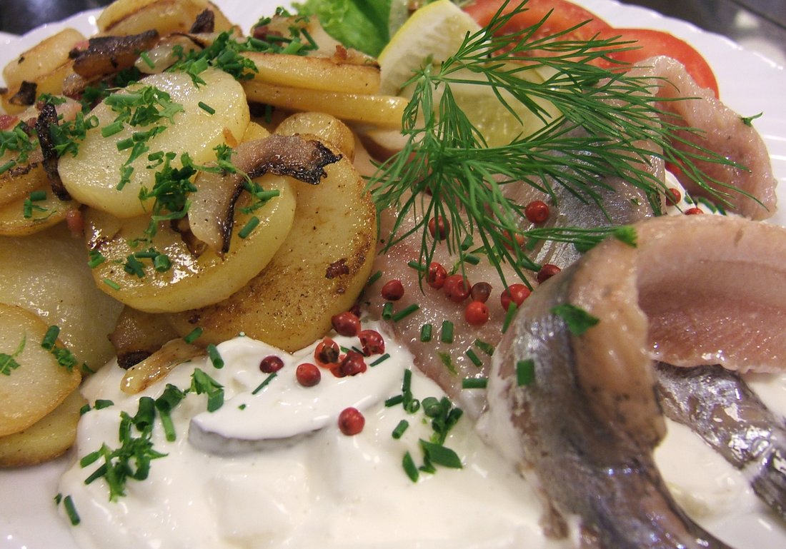 Pickled herring with fried potatoes, sour cream, dill and pink peppercorns. The cream is a dressing added at the end — the salt and the vinegar did the preserving long before