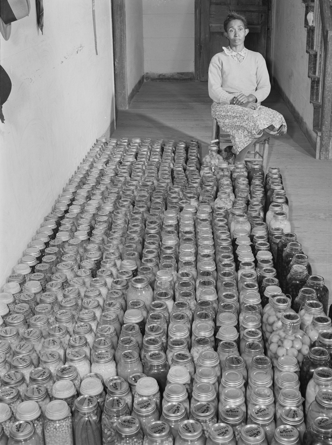 A Farm Security Administration client with her home-canned goods. This is what the history of preserving actually looks like: not a date in Mesopotamia, but somebody counting out the winter