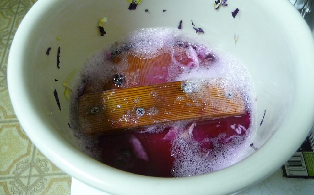 Jeff's water-seal fermentation crock with the lid off, showing a batch of cabbage weighted under the brine (placeholder)