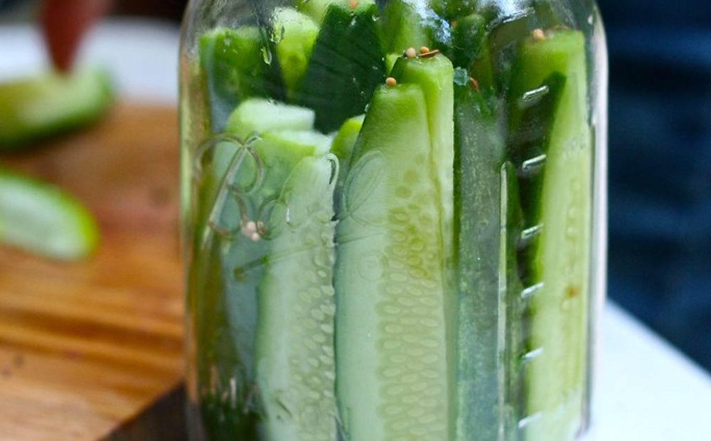 Jeff trimming the blossom end off garden cucumbers before packing a raw-pack jar (placeholder)