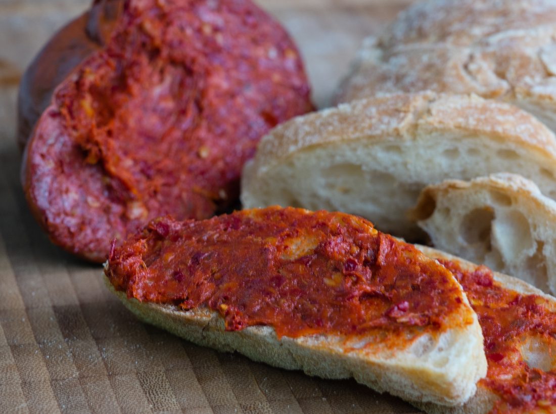 'Nduja spread on bread — the soft, fiery, spreadable Calabrian pork paste built on peperoncino, a 19th-century invention.