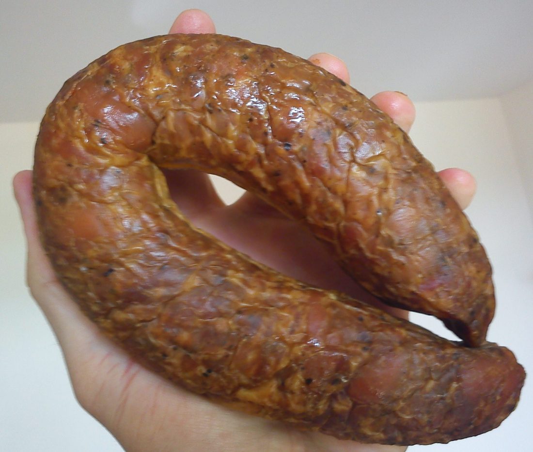The U-shaped smoked farmhouse ring, kiełbasa wiejska — the one Polish sausage most Americans mean by “kielbasa,” though it is one of dozens.