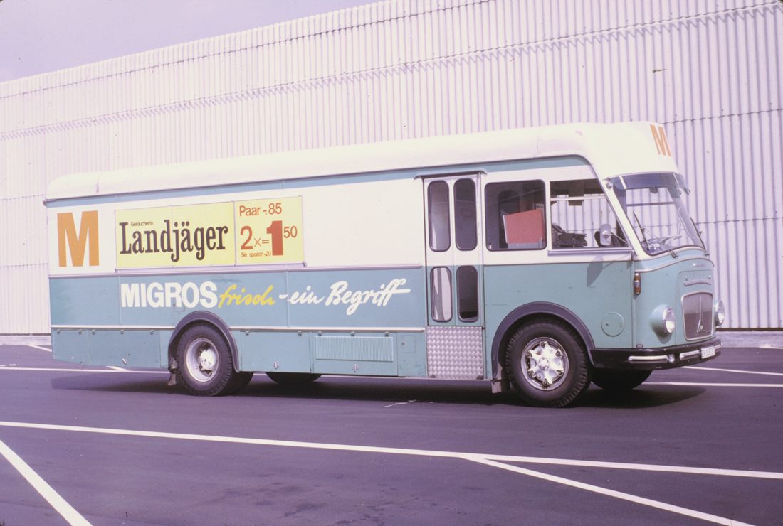 A vintage Swiss Migros sales van, its side panel advertising Landjäger two-for-one — proof that in German-speaking Switzerland this is an everyday grocery staple, not a German import, and that the "it's a German sausage" line misses a whole country.