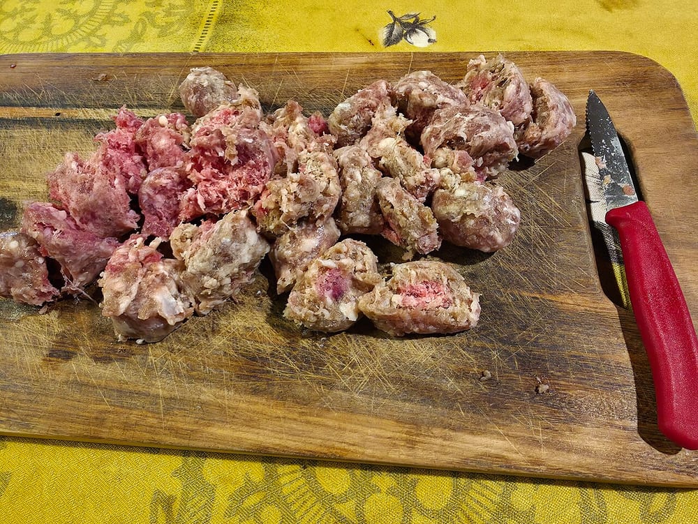 Bulk Mexican chorizo, loose and deep brick-red from ancho and paprika, breaking into crumbles rather than holding as links
