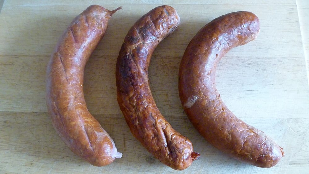 Thick, dark Cajun andouille links, gone nearly black from hickory and pecan smoke
