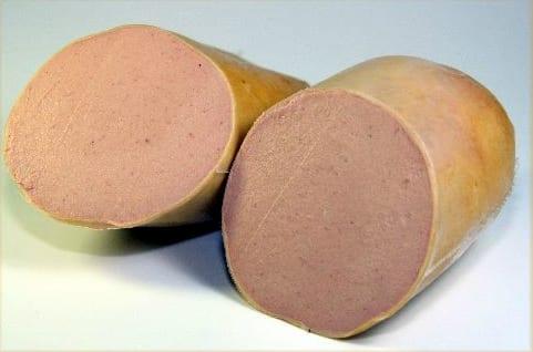 A cut chub of Braunschweiger liver sausage, the cut face pink and completely smooth — spreadable as butter