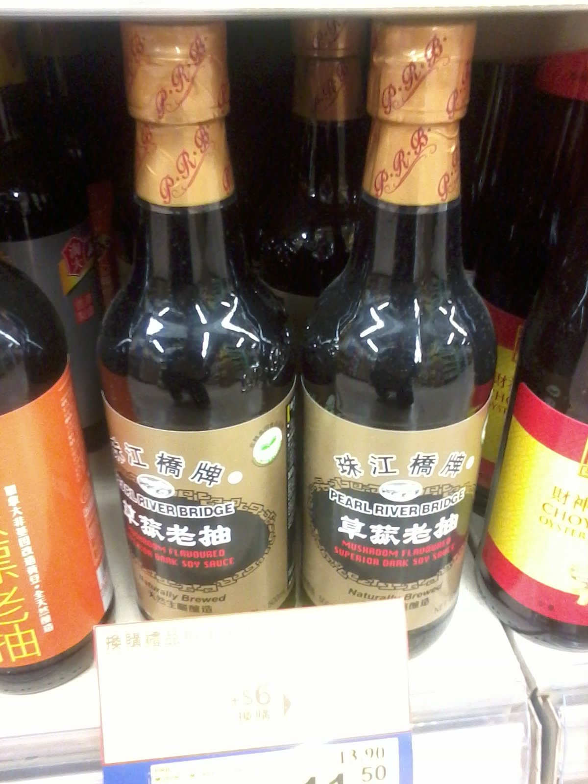 Bottles of Pearl River Bridge mushroom-flavoured dark soy sauce on a shop shelf
