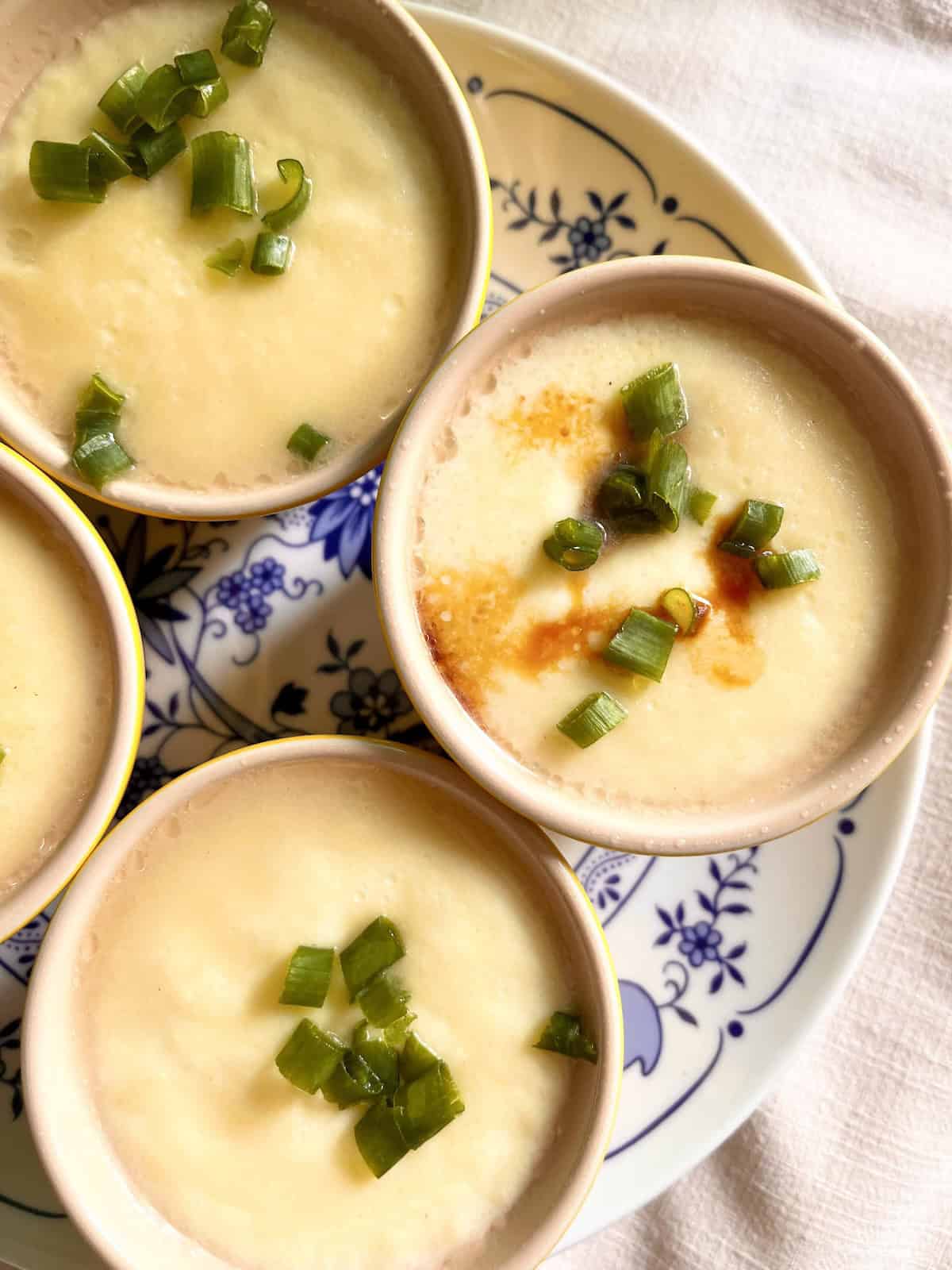 Chinese steamed egg — smooth, glossy, barely set, with soy and sesame oil