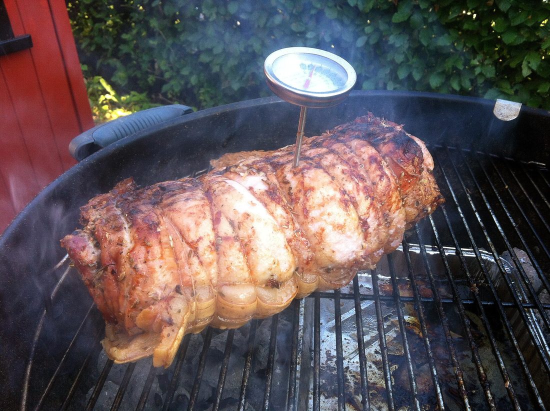 A rolled, tied porketta roast on the grill