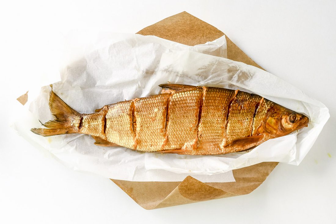 Golden smoked whitefish, glossy and honey-colored, on butcher paper