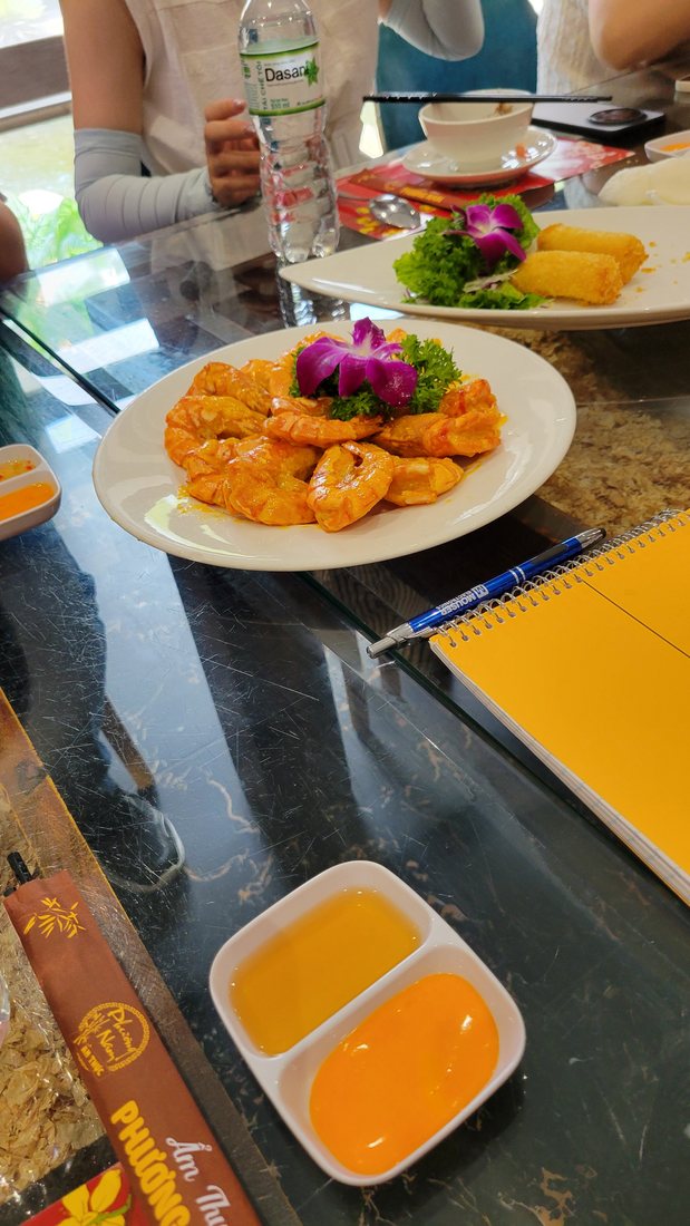 Battered and fried orange-brown pieces, plated with a two-part dipping tray
