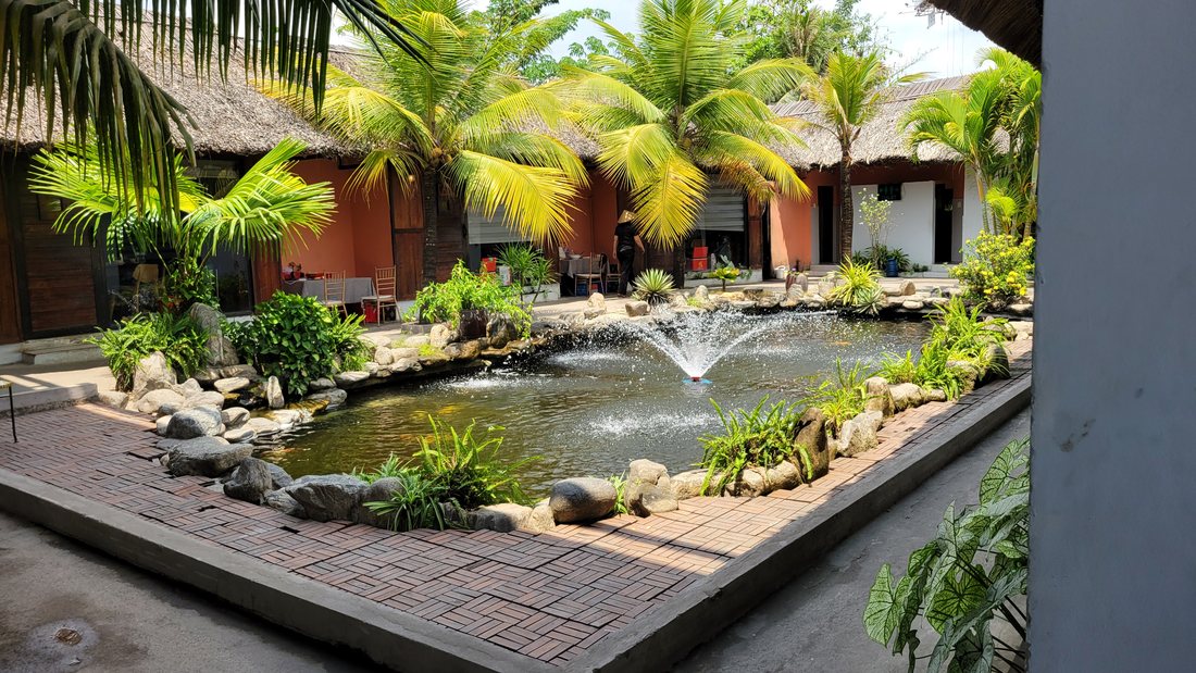 Koi pond, fountain, palms, and open-sided pavilions. This is what an hour east of Saigon looks like when somebody takes you out for lunch