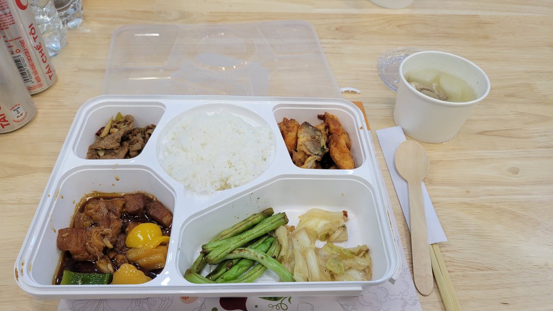 Lunch on 18 March: a compartmented styrofoam box — rice, braised meat, greens, a wedge of something pickled